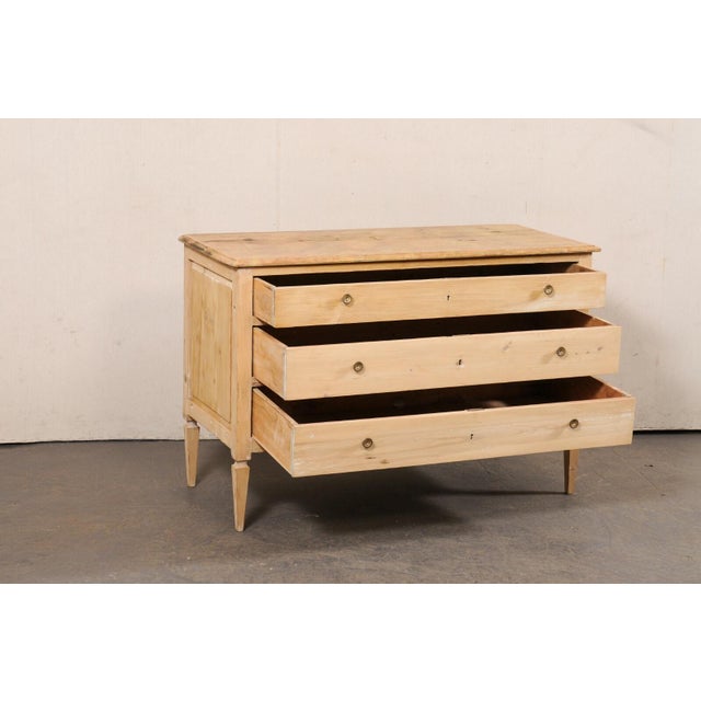 An Italian chest of drawers with faux marble top from the 19th century. This antique chest from Italy has a faux-marble...