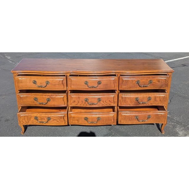 Timeless Elegance: This vintage Henredon dresser offers more than just nine drawers of generous storage; it brings a sense...