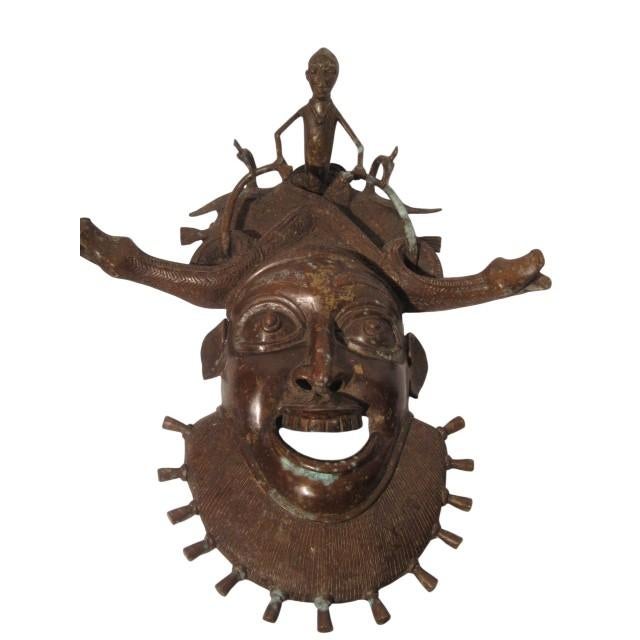 A ceremonial bronze mask originating from the Grassfields region of Cameroon, specifically from either the Bamileke or...