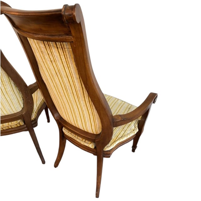 Elevate your interior with this exceptional pair of French Neoclassical Directoire style high-back armchairs, a striking...