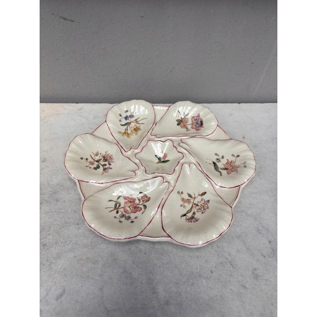 Majolica oyster plate with different flowers on each shells, circa 1900 signed Longchamp.