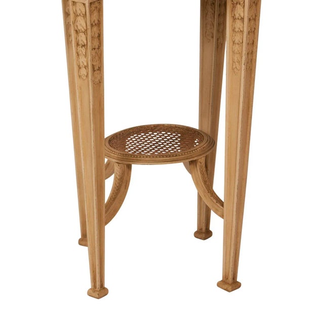 A well carved painted Louis XVI–style gueridon (small round table) inset with marble. Made in Sweden, circa 1900. The...