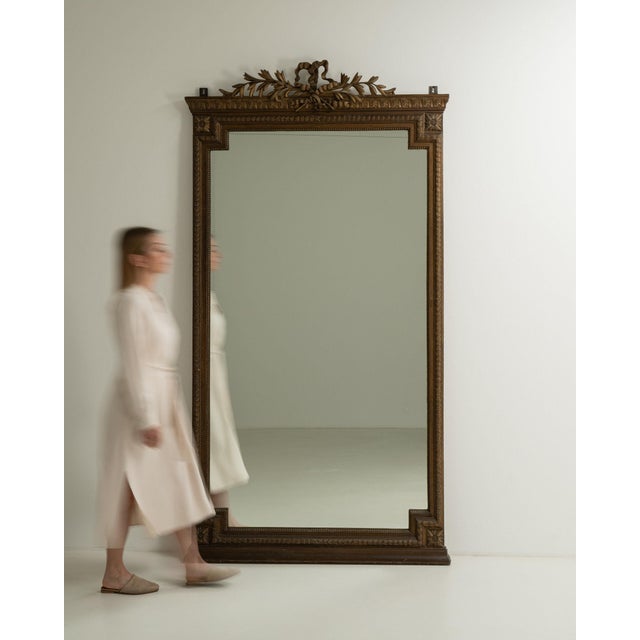 This mirror carries genuine presence, its dark carved wood frame with crest, floor-length tall immediately setting the...