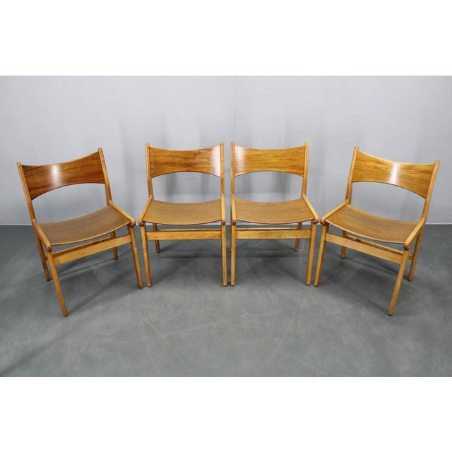 This elegant set of four mid-century modern dining chairs was produced in Denmark during the 1960s. The chairs combine a...