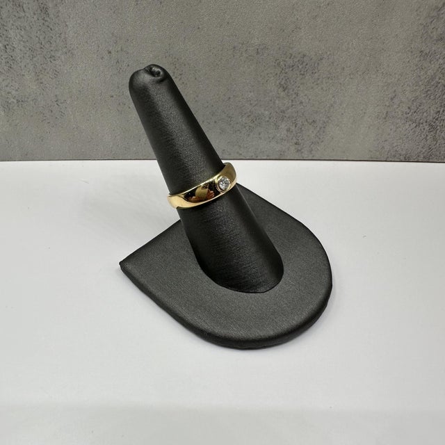 This elegant Bezel Set Diamond Dome Ring in 10kt Yellow Gold features a stunning 0.15 carat total weight (ctw) of natural...