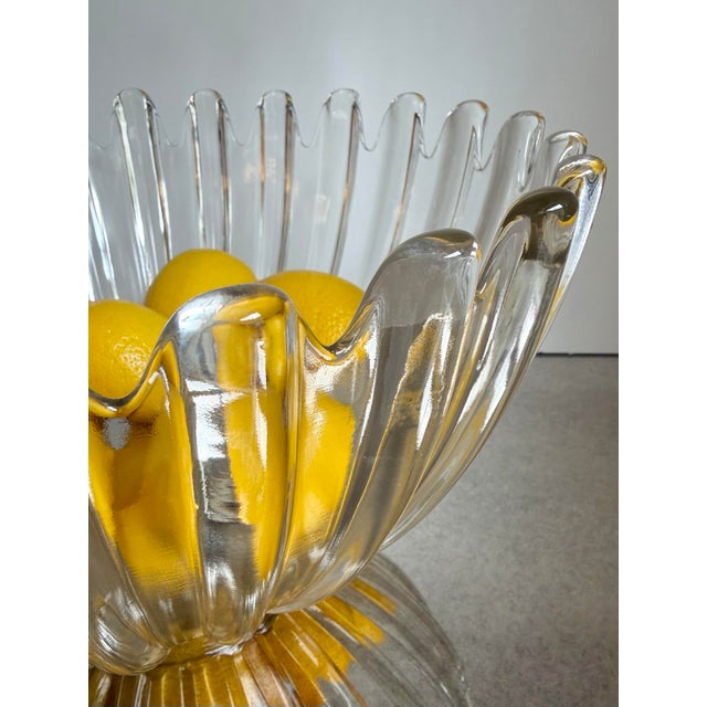Large vintage ribbed glass centerpiece bowl in heavy clear molded glass with a dramatic undulating rim and sculptural...