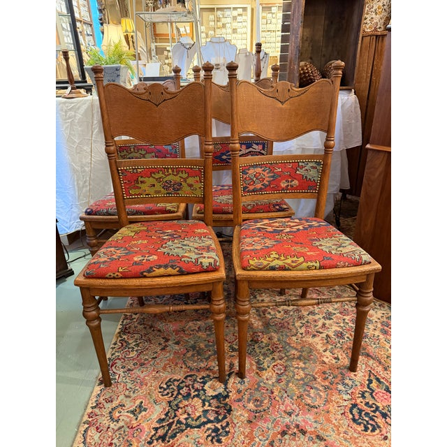 This is a set of six, oak dining chairs date to the early 1900s. The chairs have been refinished and reupholstered with a...
