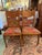 This is a set of six, oak dining chairs date to the early 1900s. The chairs have been refinished and reupholstered with a...
