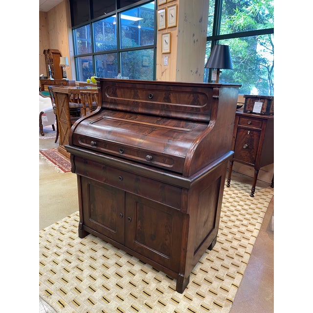 A refined vintage roll top writing desk crafted in richly grained mahogany. The gracefully curved roll top design conceals...