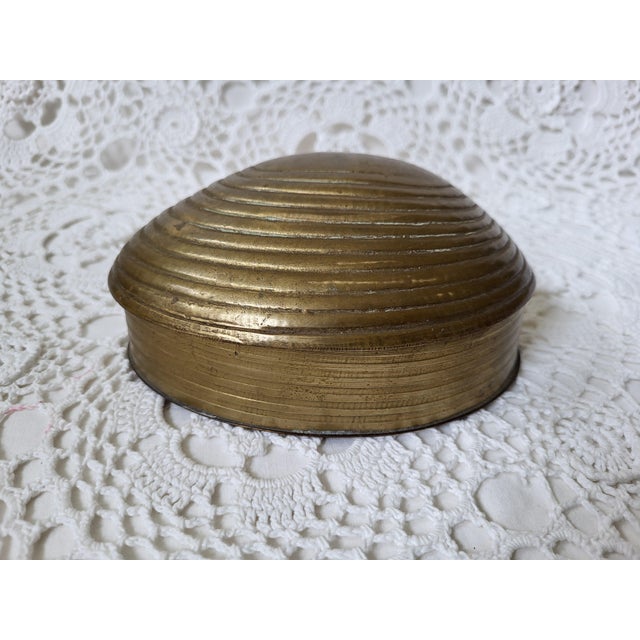 Brass shell trinket box, perfect for a coastal home. Measuring 5 ¾” l x 4 ¼” w x 2 ½” h and showing general wear. Wouldn't...