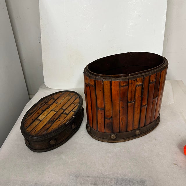 Vintage oval bamboo lidded box with stud details. Size is good to keep lots of everyday clutter out of sight. Measures 10”...