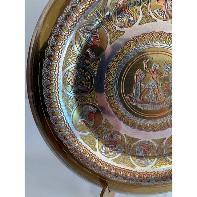 Chairish Description: A finely engraved Egyptian revival plate in layered brass, copper, and silver-toned metals. A...