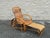 Unusual vintage rattan lounge chair featuring a reclining back and an ingenious integrated pull-out ottoman. The footrest...