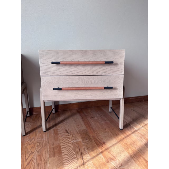 A beautifully understated pair of Rosedale Nightstands by Four Hands, combining clean architectural lines, warm oak tones,...