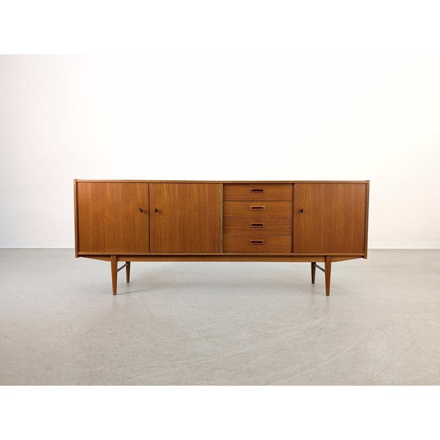 We are offering a beautiful vintage teak sideboard from the 1960s-70s for sale. with three doors and four drawers, this...