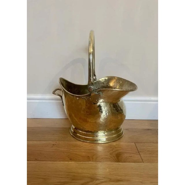 Antique Victorian quality brass helmet coal scuttle having a shaped movable carrying handle with a shaped quality brass...