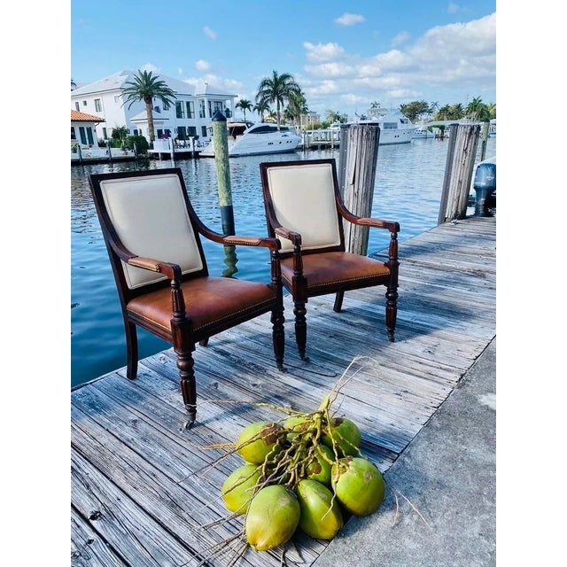 A Classic Pair of iconic and enduring style of Ralph Lauren arm chairs with a beautiful distressed cognac leather seat....