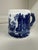 A charming vintage blue and white transferware mug featuring wraparound pastoral landscapes, quaint village scenes, and...