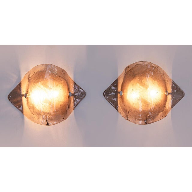 Elegant pair of kalmar wall sconces made of handblown smoked / amber murano glass mounted on white back plates. Made in...