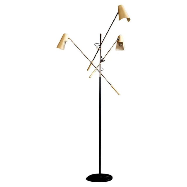 A rare Mid-Century Modern floor lamp by Stilnovo. This sculptural piece features three fully adjustable arms with brass...