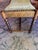 Antique footstool with barely twist legs and a carved wooden apron. I’ve read it’s from 1910 but I’m not sure. Could use...