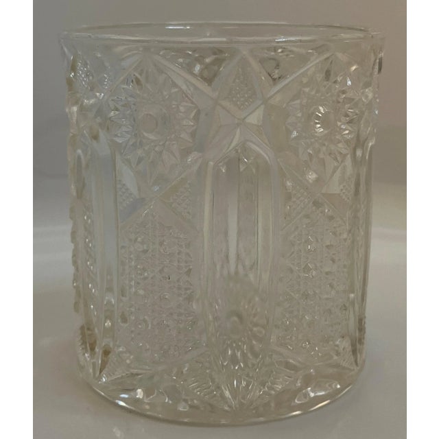 Pretty embossed glass jar. Has been used as a decorative piece but could be used to hold candies, colorful ornamental...