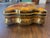 A large porcelain box with a beautiful gold and painted decoration.