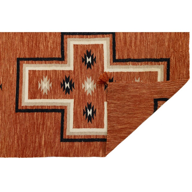 Elevate your hallway or entryway with this stunning modern Navajo-style wool runner. Featuring a rich terracotta orange...