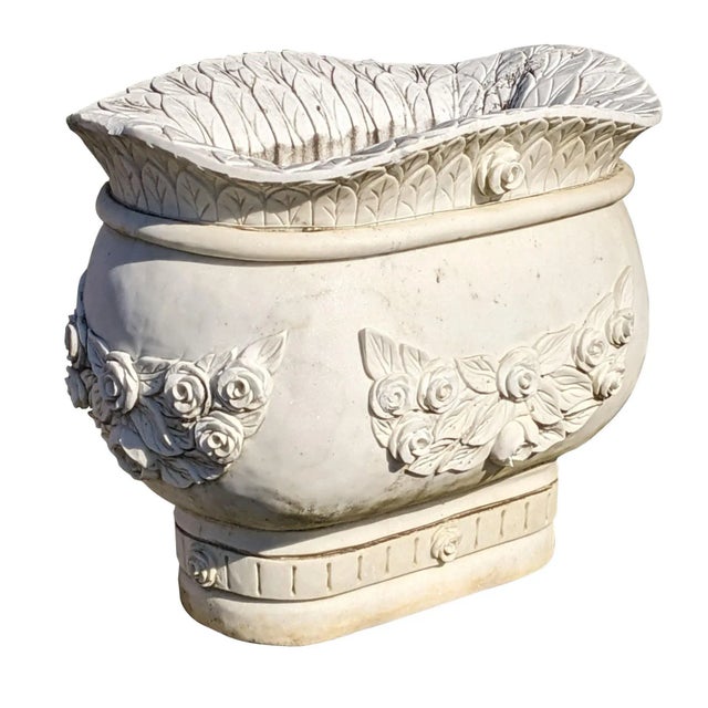 A stately pair of Italian Marble rose jardiniere urn planters. Each massive pot is beautifully decorated with a rose and...