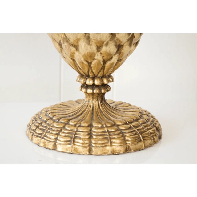 A pair of gold leaf composition lamps in a pineapple shaped design. Height is 19 inches from the base to the top of the...