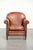 This comfortable vintage sheepskin armchair finished with decorative nails. This vintage sheepskin armchair has a...