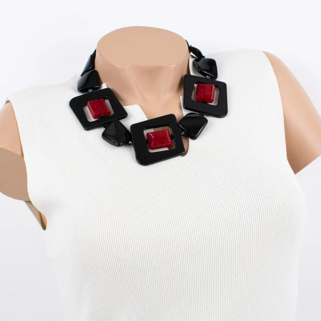 This lovely Angela Caputi, made in Italy, resin necklace works on black and burgundy-red contrast. The choker features...