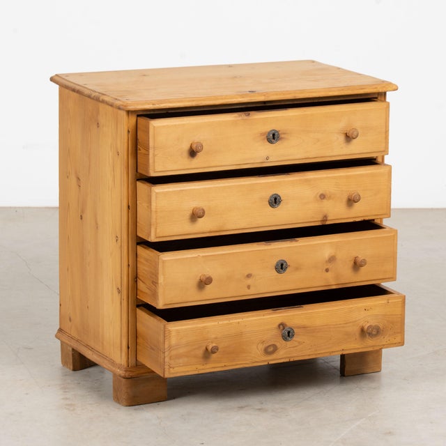 Early 20th century Danish small chest of four drawers, crafted in pine with a natural wax finish that brings out the...