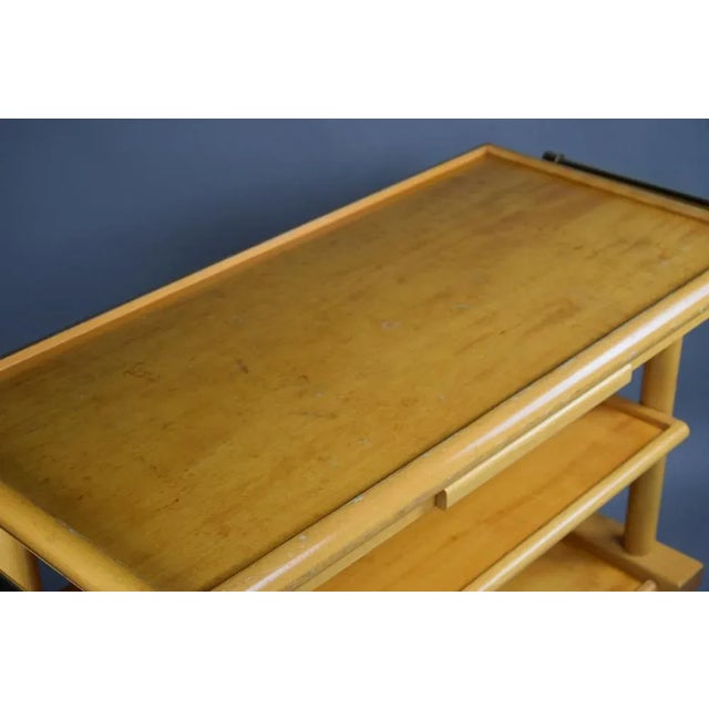 Big, stylish and robust three trier serving trolley in wood and brass.