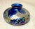 The vintage hand blown Kent Fiske blue iridescent vase is a unique and artistic piece of glassware. Made in 1982, this...