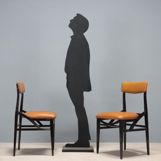 Set of dining chairs with stained beech wood frames and brown vinyl seat and backrests. These chairs are suitable for...