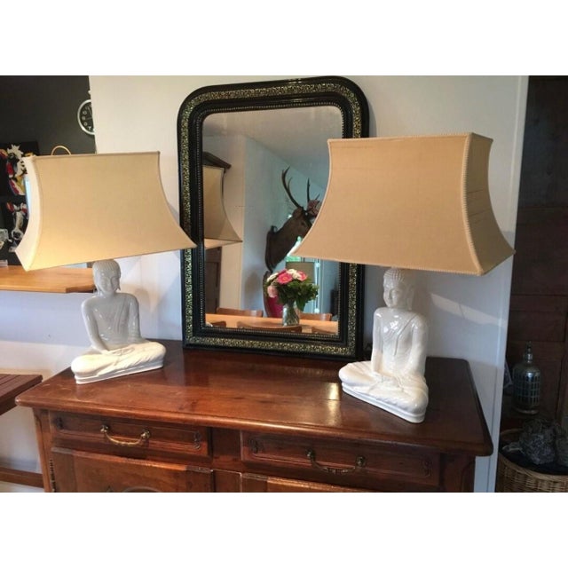 A luminous and soothing presence. This superb pair of table lamps features a seated Buddha in a meditative pose, sculpted...