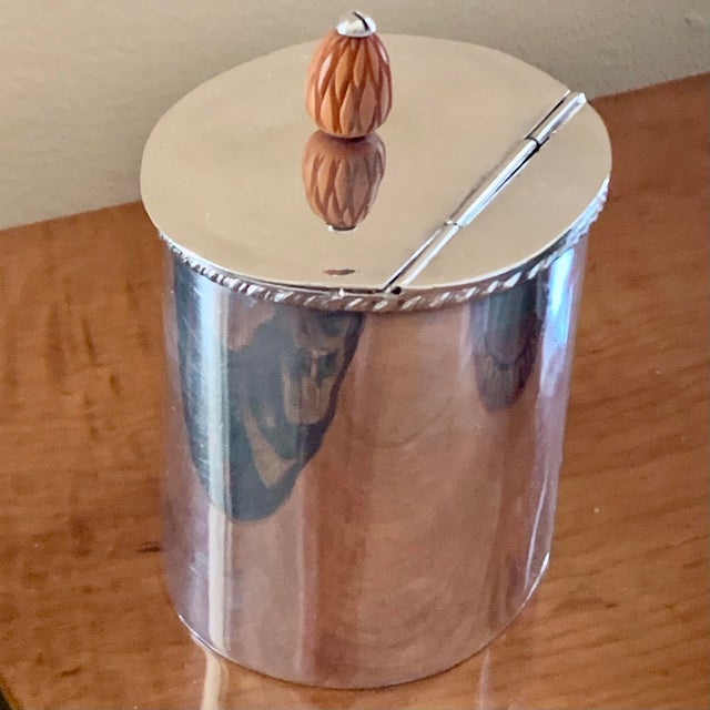 A chic little Edwardian tea caddy, oval with a rope twist border around he top and an unusual partly hinged lid with a...
