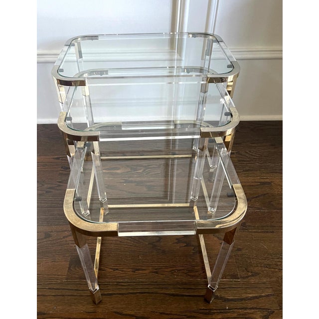 A set of three nesting tables by Charles Hollis Jones circa 1970s. The metric line employs Lucite frame construction with...