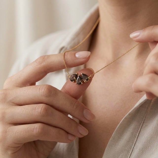 Bring rich, earthy sophistication to your style with this cluster pendant necklace, featuring three sparkling deep-tea...