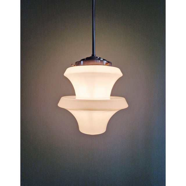 Art Deco pendant light in white opaline with a chrome-plated metal frame, 1920s-30s. The globe has a particularly original...