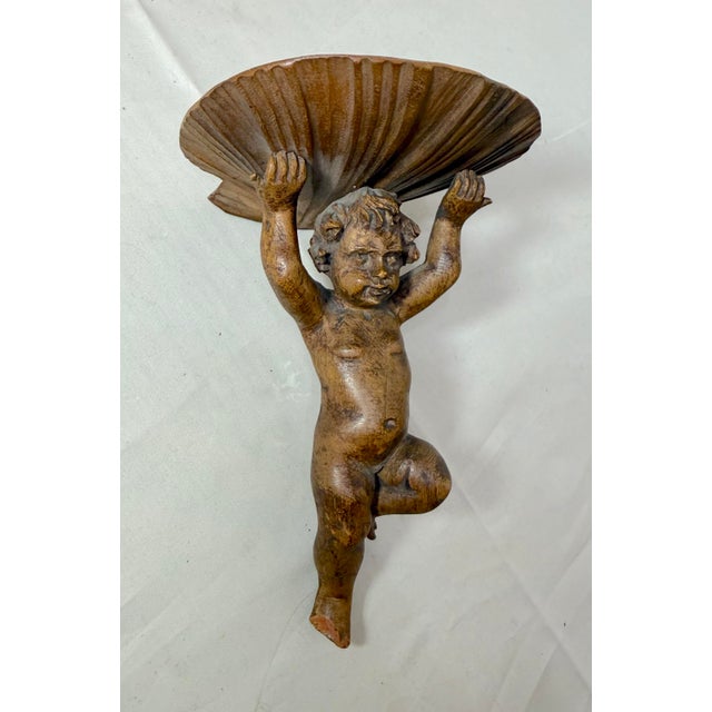 This antique hand-carved Victorian cherub wall shelf sculpture from the 19th century is a unique and beautifully crafted...