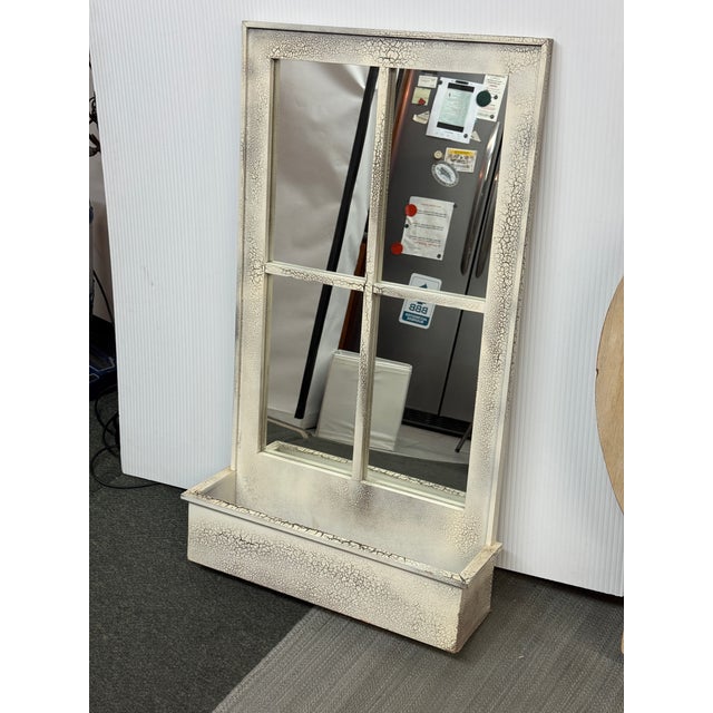 Design Plus Gallery presents a Vintage Style Wall Mirror. Window Pane frame in off white crackle finish house a reflective...