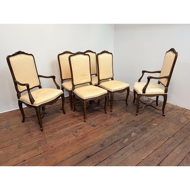 A set of six stylish French Provincial style dining chairs. The set consists of two large and roomy armchairs and four...