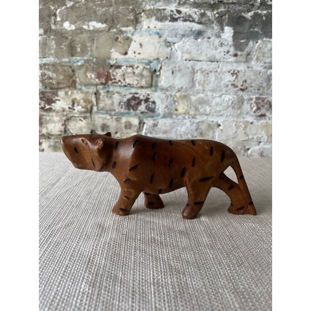 Description: Bring a touch of the wild to your space with this striking hand-carved wooden leopard, crafted in Kenya. This...