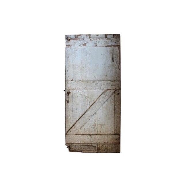 The seller says: "We stumbled upon this beautiful antique barn door with gorgeous worn white paint circa 1906, and knew it...