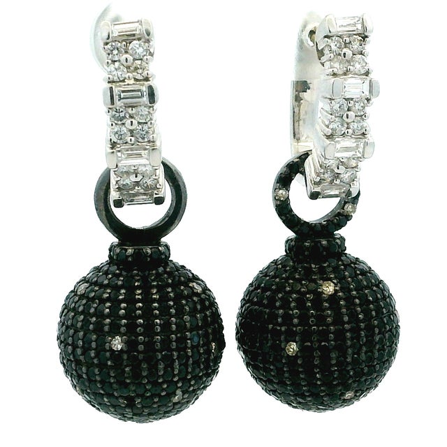 A glamorous pair of convertible earrings crafted in substantial 18K white gold and set with approximately 5.00 carats of...