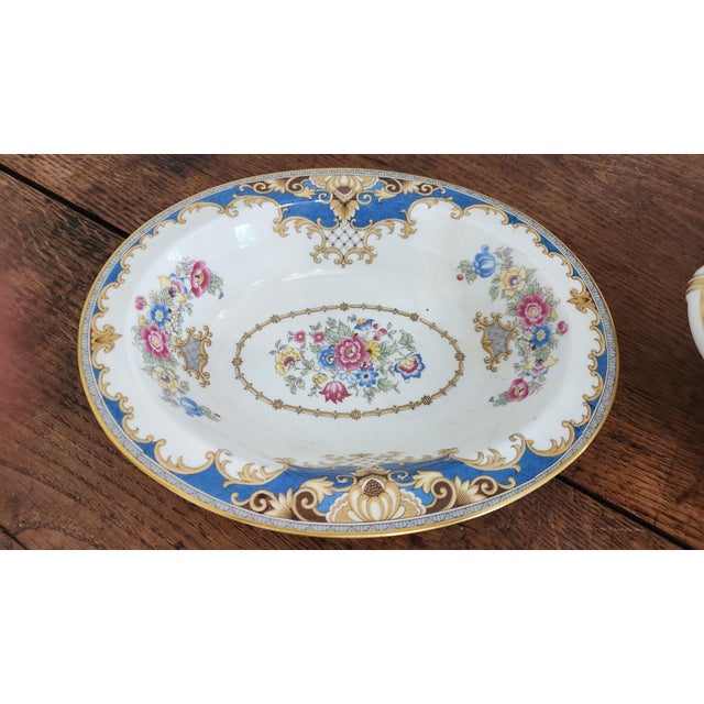 An elegant 16-piece vintage bone china serving collection by Shelley of England in the highly decorative Sheraton pattern,...