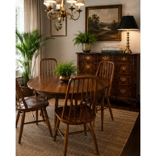 Charming vintage dining chair set by Virginia House, crafted from solid oak with a warm medium-brown finish that...