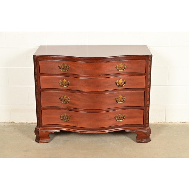 An exceptional Georgian or Chippendale style serpentine front dresser or chest of drawers By Baker Furniture, "Historic...